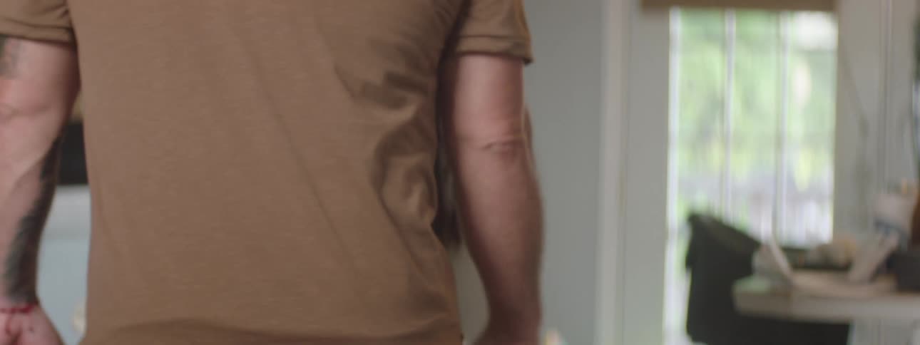 Two people walking in a room of the house