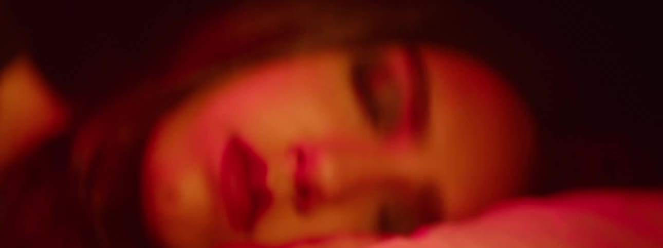 A dynamic light effect predominantly in shades of red with abstract and blurred shapes that resemble lens flares or light leaks these vibrant luminous forms move and shift across the dark background creating an atmospheric and artistic visual