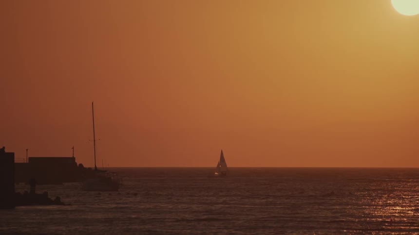 The boat is sailing at sunrise