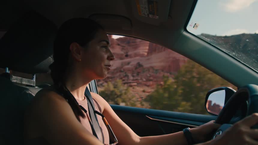 Woman driving a vehicle in a natural area