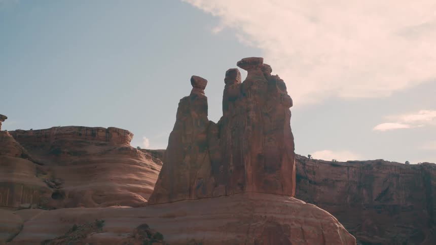Large sandstone rock formations rise prominently in a desert landscape