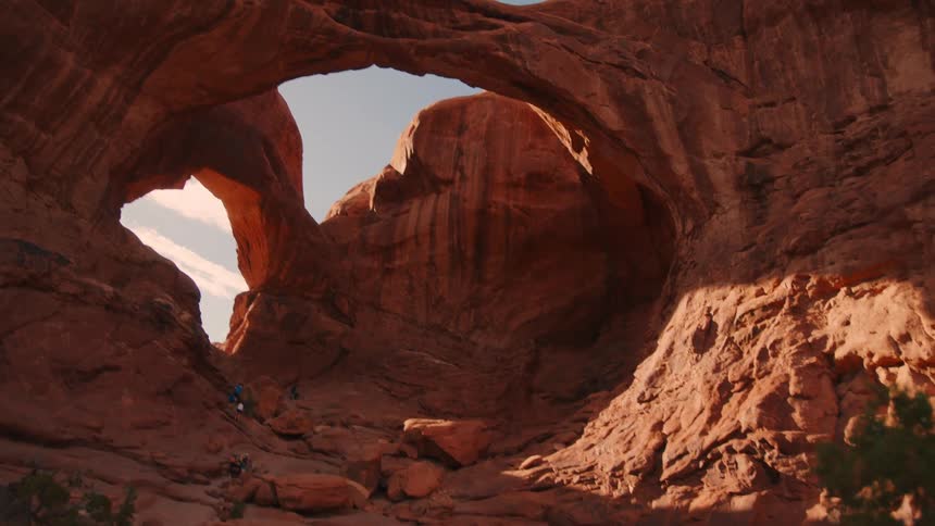 A canyon with rocks forming a natural arch at midday