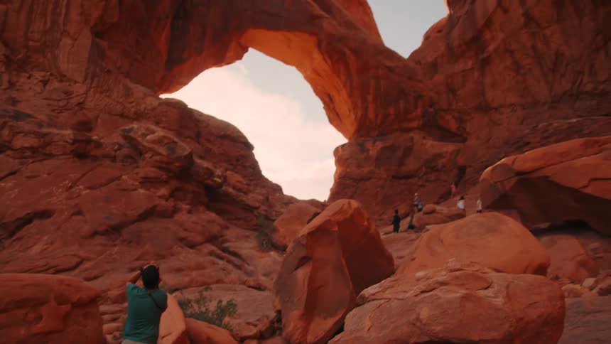 Group of travelers in a natural environment with rock formations and canyons