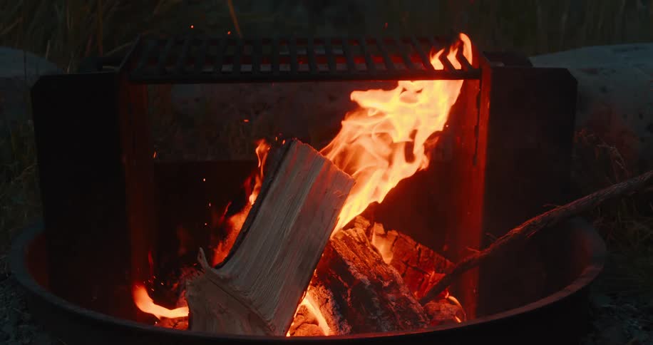 Firewood burning in an outdoor fireplace