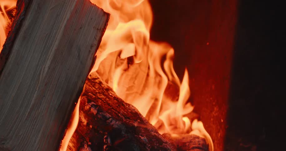 Wood burning in flames of fire at night time
