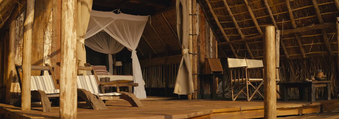 A wood cabin has chairs inside