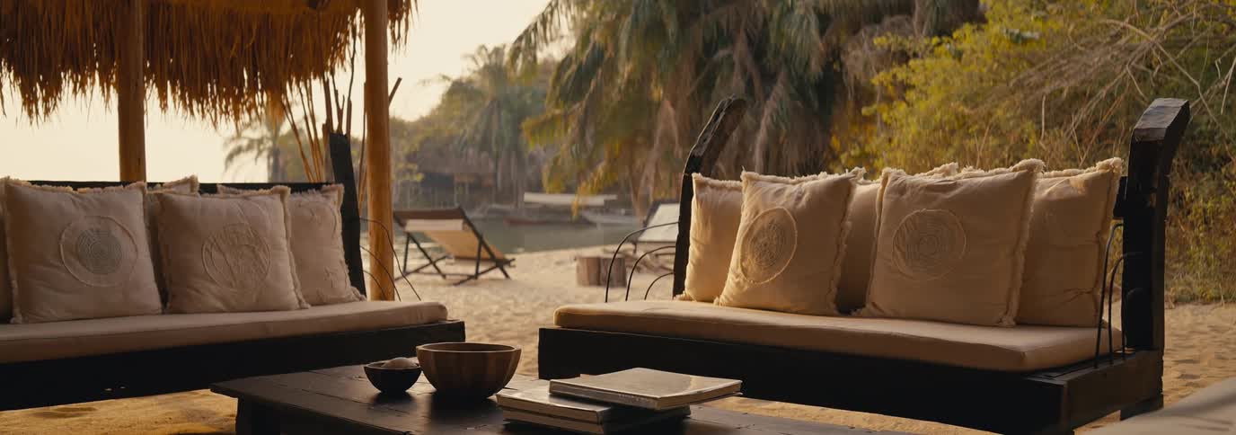 Sofas with cushions on the sand by the sea on a beach