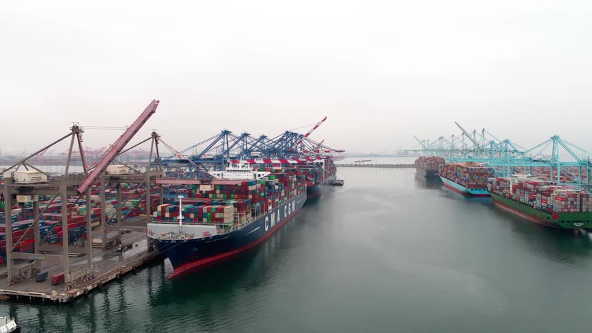 Landscape of the  Los Angeles seaport at dawn with docked ships full of containers