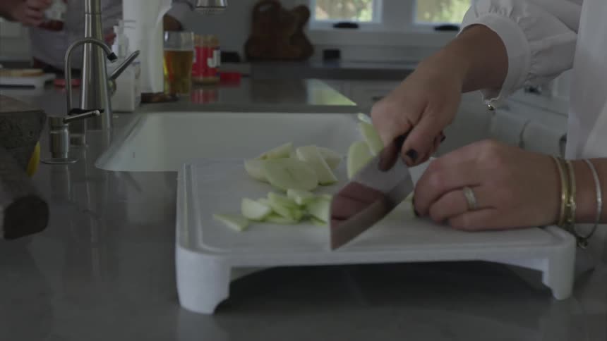 A person cutting produce