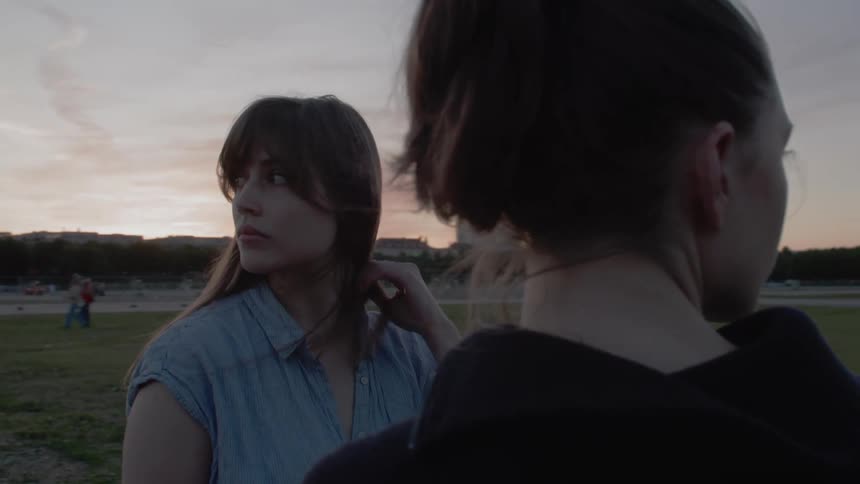 Two women look in opposite directions