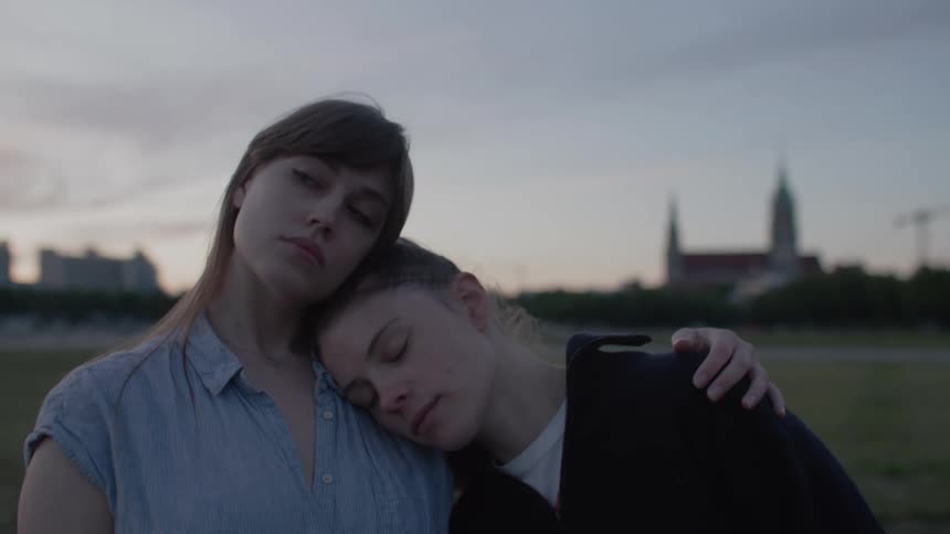 A woman rests her head on a friends shoulder