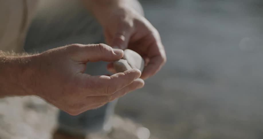 Pair of hands holding a stone
