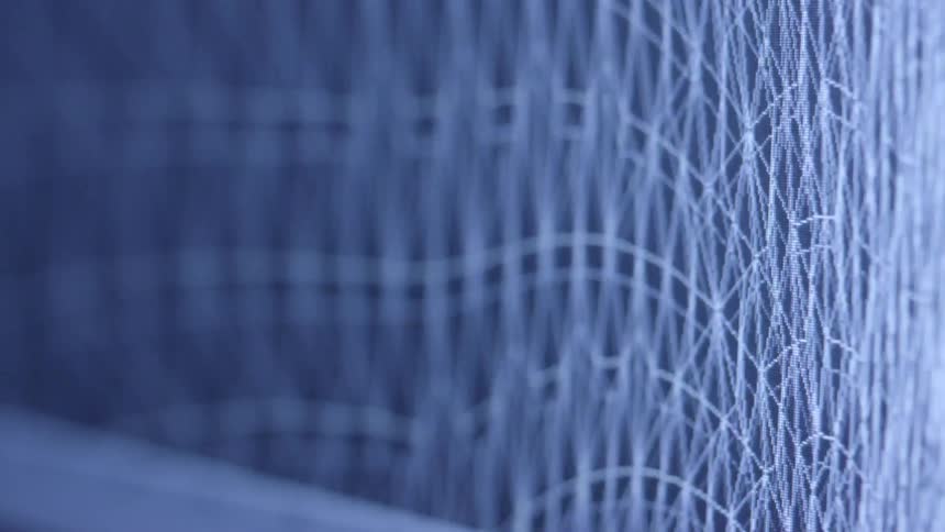 A closeup screen shows a grid of white lines forming a complex wavelike pattern against a dark blue background