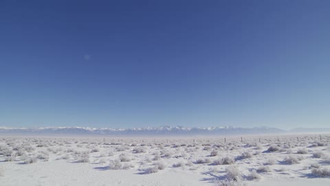 The sky is clear over the snow covered field