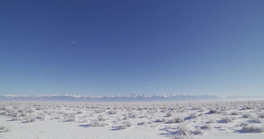 The sky is clear over the snow covered field