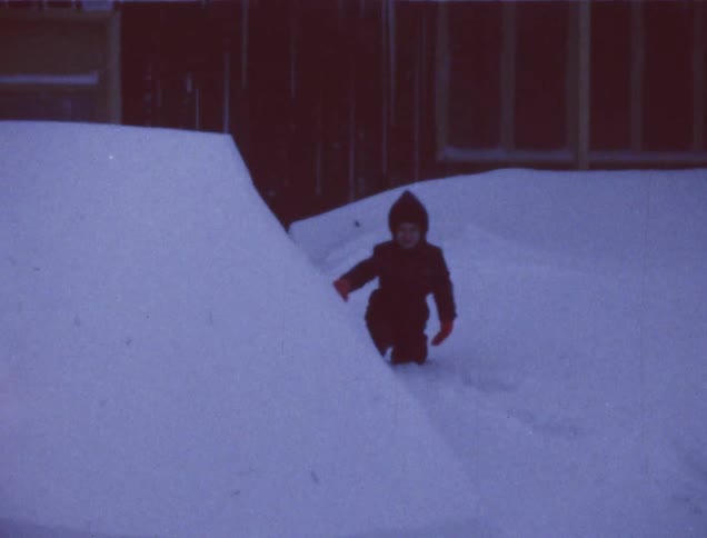 A child walks in the tall snow