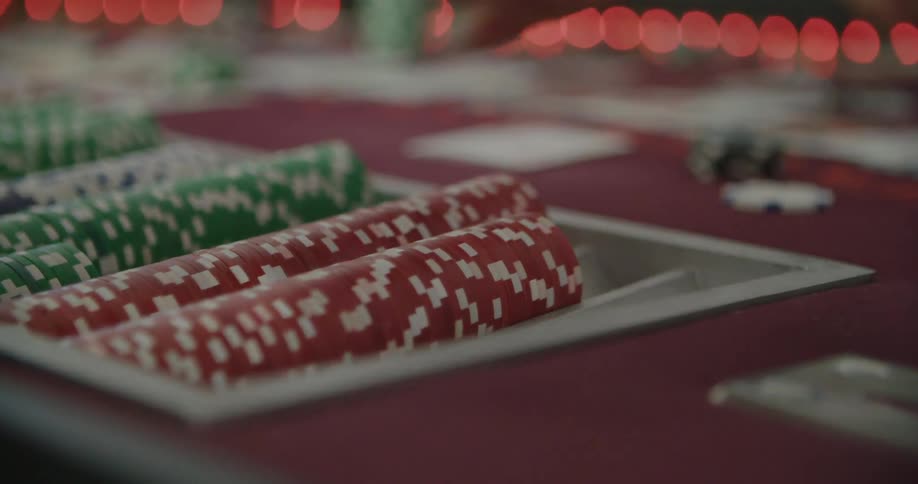 A hand grabbing poker chips