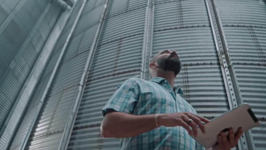 A man is holding a clipboard in the silo