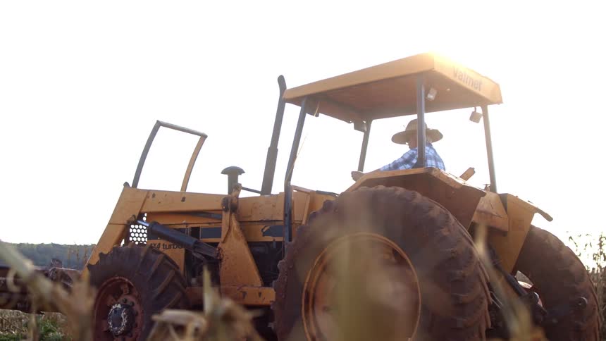 Smoke rises from the tractor on the farm