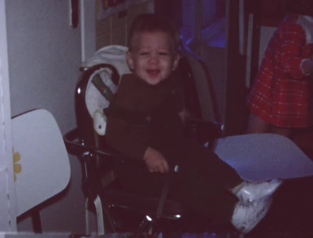 A child climbs onto a highchair