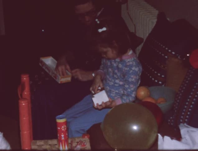 Children open presents at home