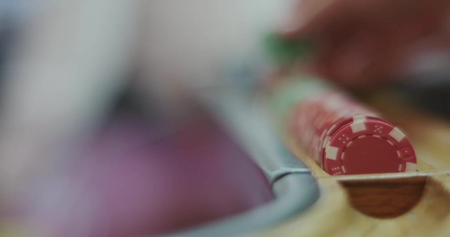 A person puts casino chips into a tray