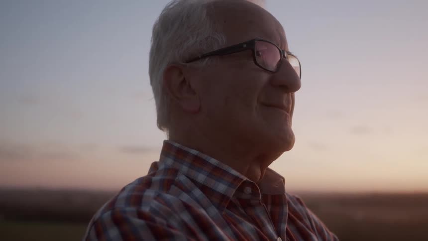 Man watching the sunrise on the farm