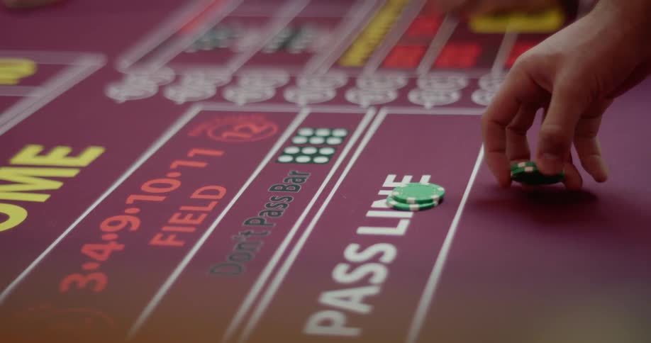 Hand picking up chips on a casino table