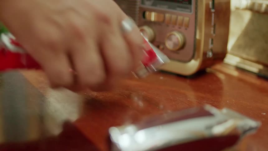 Hand picking up a hair cutting machine