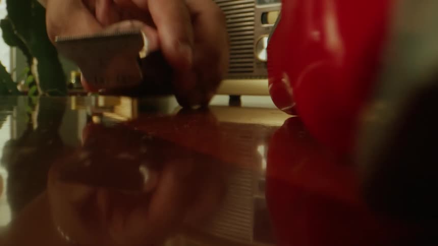 Hair cutting machine being placed on top of a wooden table