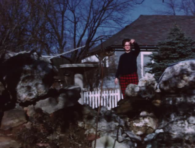 A woman walks from her car waving