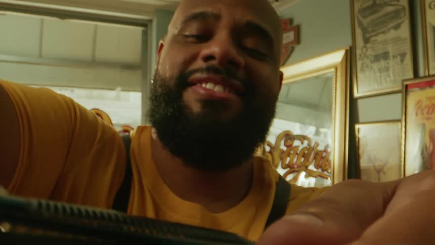 Happy barber cutting a customers hair
