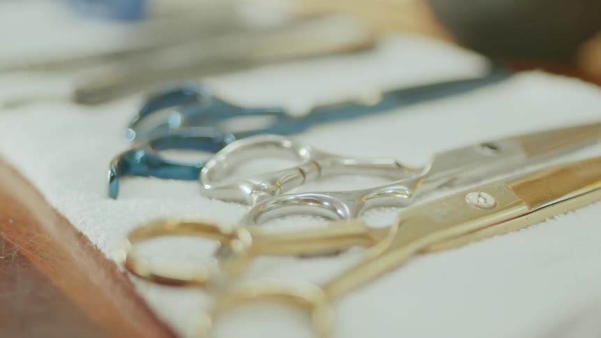 Hairdressing scissors on a white surface