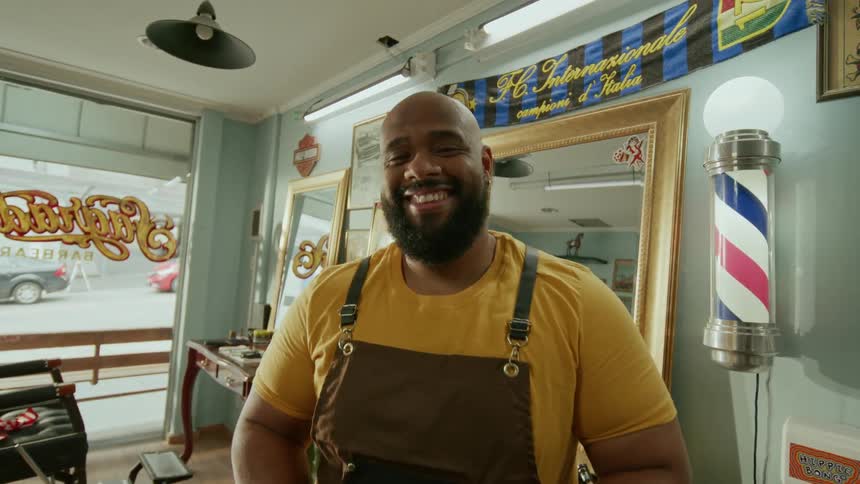 The barber smiles in his shop
