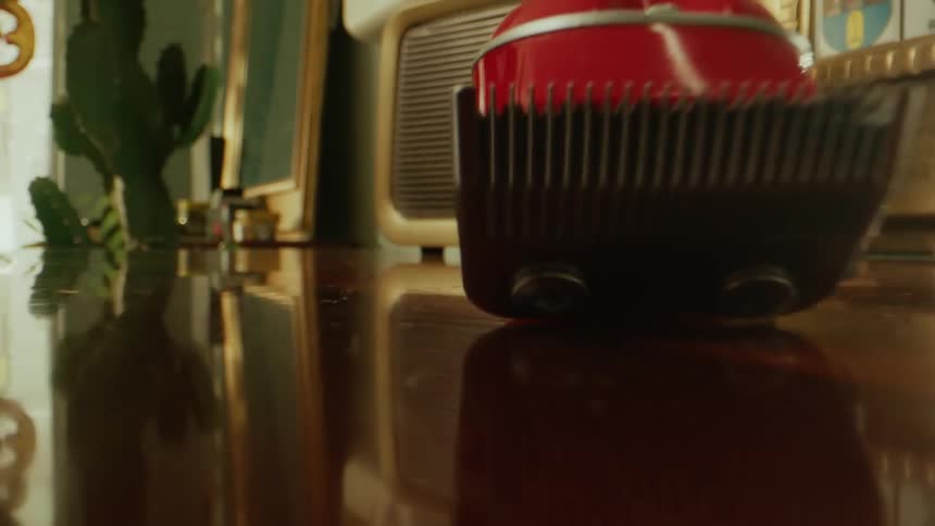 Close up of a silver hair clipper picked up from a tabletop by a barber in a salon during daytime