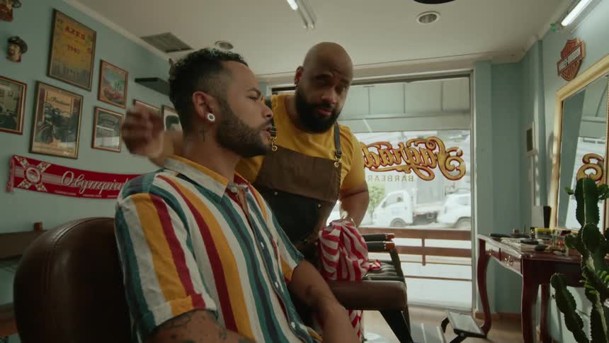 A barber and customer discuss a haircut in the barbershop