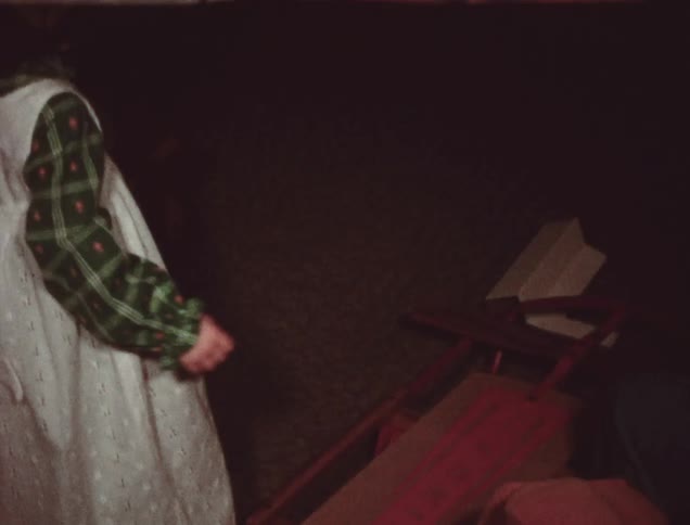 A young girl smiles holding a sled