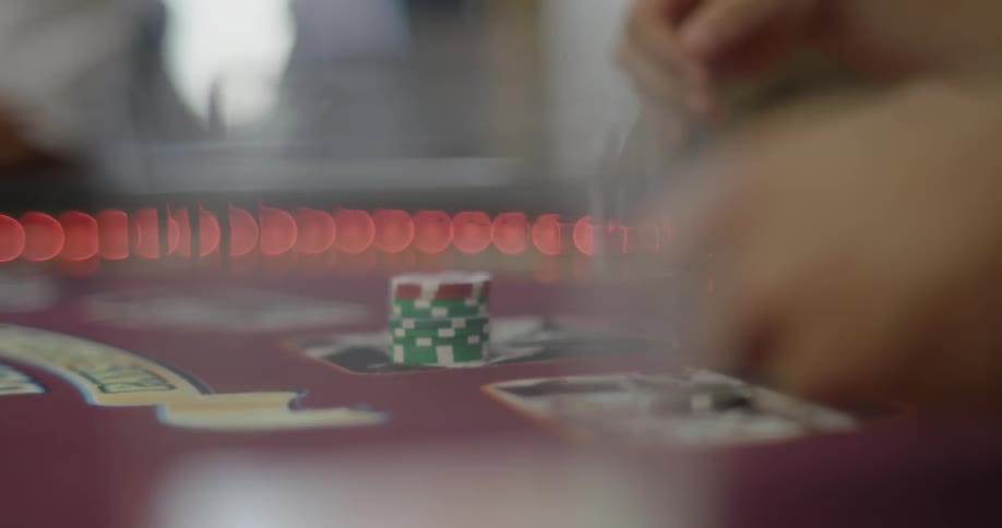 A person sitting at a table with chips and numbers on the table