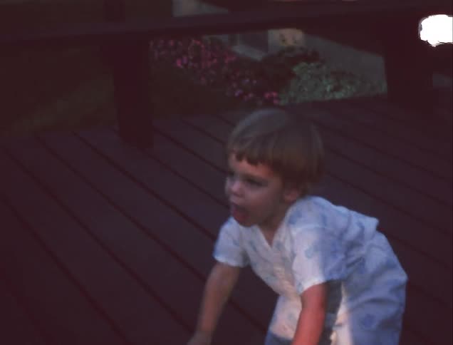 Child walking and taking off hat