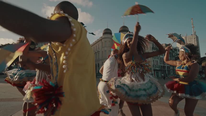 The dancers are happy and spinning around outside