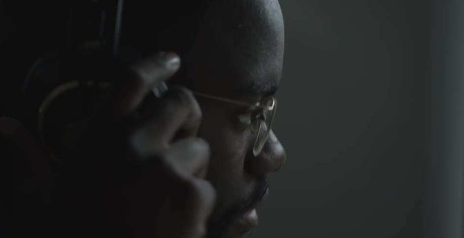 A person wearing glasses and headphones