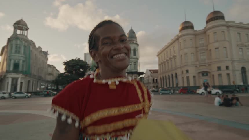 Joyful dancer in festive attire in historic city square