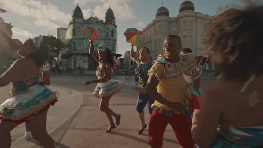 A group of people in costume are dancing in the city