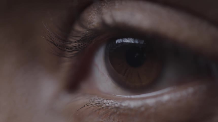 A persons eye with brown eyeballs