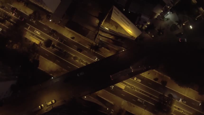 Cars travel on the roads at night in the city