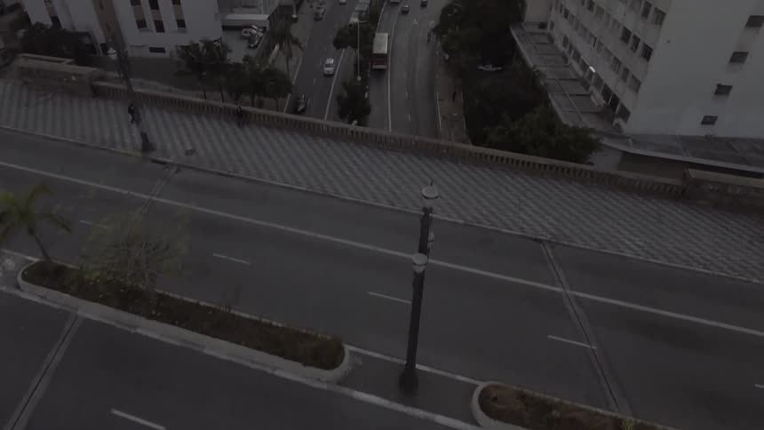 Cars and buses travel on the road in the city