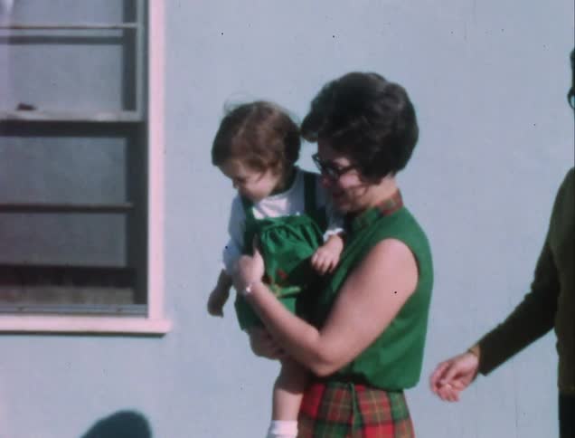 A woman carries her baby