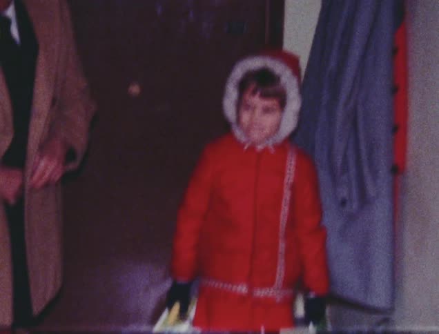 A child is walking with some bags