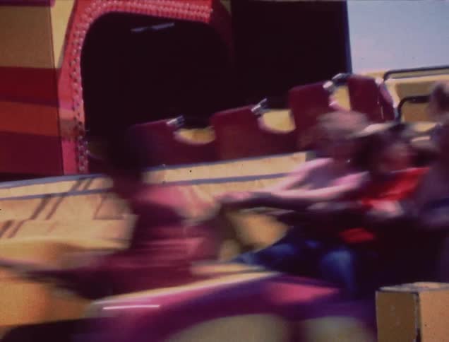 People are riding a fast roller coaster