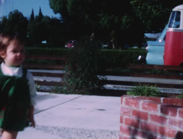 A little girl runs around a corner